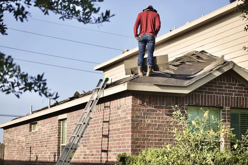 Professional roofer working on a residential roof in Sanibel